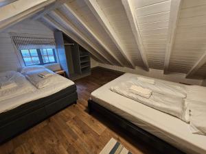 two beds in a room with a attic at Trollbu Aabrekk gard in Briksdalsbre