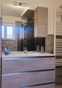 a large bathroom with a sink and a mirror at Villa Valentina in Madonna dellʼAcqua