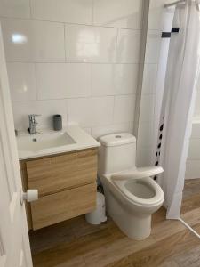 a bathroom with a toilet and a sink at Casa con vista al mar en Caldera in Caldera