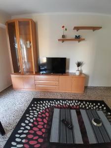 a living room with a tv and a entertainment center at LAS 4 ESTACIONES in Elda