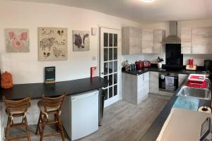 a kitchen with a counter and two chairs in it at No.46, comfortable 2 bedroom property in Rothes