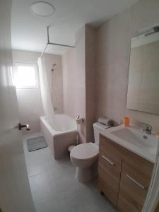 a white bathroom with a toilet and a sink at LAS 4 ESTACIONES in Elda