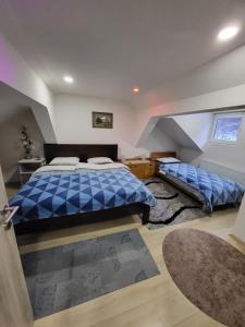 a bedroom with a blue bed in a attic at Tiha dolina in Železniki