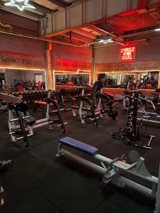 a gym with a bunch of exercise equipment in it at Maze apartments and rooms in Hull