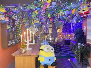 a restaurant with a bar with christmas lights at Orange House in Osaka