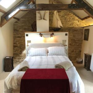 ein Schlafzimmer mit einem großen weißen Bett in einem Zimmer in der Unterkunft Luxury Exmoor Barn conversion with Sauna in Exford