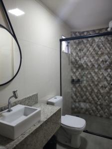 a bathroom with a sink and a toilet and a shower at Morada Stucchi in Balneário Camboriú