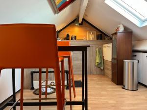 an attic kitchen with a table and two chairs at 2 privé verdiepingen in stadswoning, bij Station en centrum in Venlo