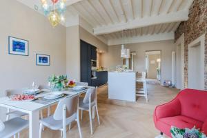 a dining room and living room with a white table and chairs at Casa Pino 2 bedrooms 2 bathrooms contemporary apar in Lucca
