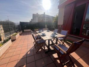 un patio con mesa y sillas y ordenador portátil en Apartamento Rovacias, en Comillas