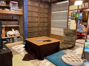 a living room with a table and a chair at wagaranchi in Kumano