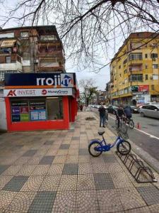 a blue bike parked on a sidewalk next to a street at Villa Rroji in Shkodër