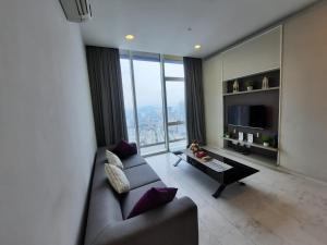 a living room with a couch and a large window at Platinum Suites Kuala Lampur by Likehome in Kuala Lumpur