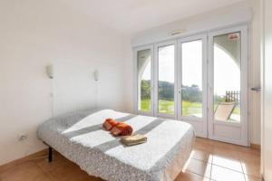 a bedroom with a teddy bear sitting on a bed at Location 2 pièces sur EZE à 3km de MONACO (2) in Èze