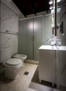 a bathroom with a toilet and a sink at COMPLEJO LA CASCADA ESQUEL in Esquel