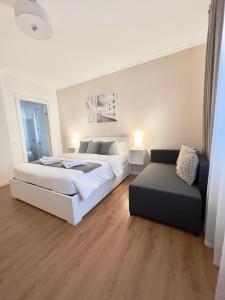 a bedroom with a large bed and a couch at Corso Venezia in Mestre