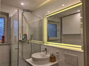 a white bathroom with a sink and a mirror at Soleil Rooms - Pure Living in the City Center in Hannover