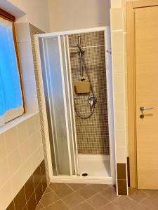 a shower with a glass door in a bathroom at Maso Gaitem in Drena