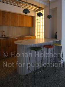 a kitchen with a counter and stools in a room at Studio Heinrich 1 in Tutzing