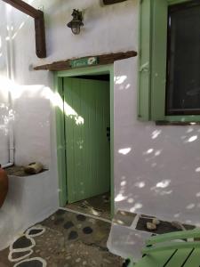 a green door in the middle of a room at Elma's Houses - Green House Yanna in Alonnisos