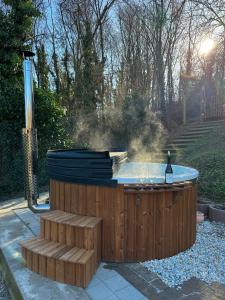 a hot tub in a backyard with a grill at East Mountain Villa in Batina
