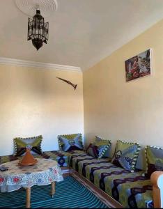 a living room with a couch and a table at Titanic House by ahmed in Mirleft