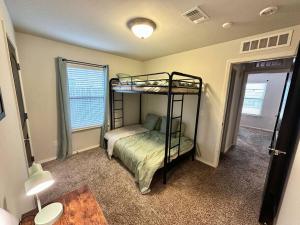 a bedroom with two bunk beds in a room at Sweet Oasis in Edmond