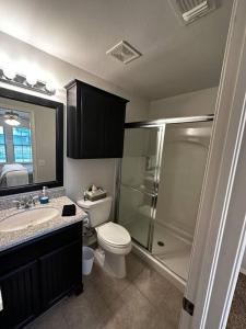 a bathroom with a shower and a toilet and a sink at Sweet Oasis in Edmond