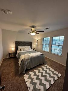 a bedroom with a bed and a ceiling fan at Sweet Oasis in Edmond