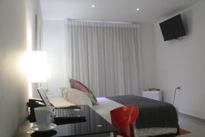 Säng eller sängar i ett rum på Hotel Golden House