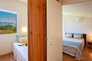 a bedroom with two beds and a window at Residence Agula Mora in Lecci