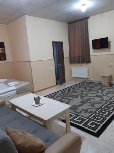 a living room with a couch and a table at Lind Guest House B&B in Gyumri