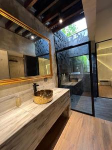 a bathroom with a sink and a large mirror at Hotel Suites Lounge Cañasgordas in Cali
