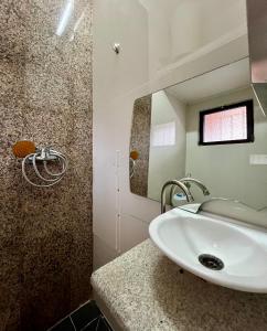 a bathroom with a sink and a mirror at Blue Sea Studio 1 minute away from Luanda Bay in Luanda