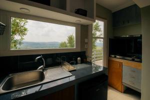 a kitchen with a sink and a large window at Olympian Heights in Olympia +11 photos
