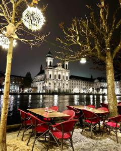 a group of tables and chairs in front of a building at Casa Carvalho in Lucerne