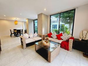 KRAAM VILLAS في تالانغ: غرفة معيشة مع أريكة وطاولة