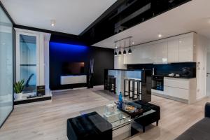 a living room with a black and white kitchen at Diamonds Apartment in Krakow