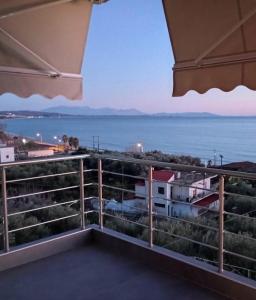 a view of the ocean from the balcony of a house at Spiros Rooms in Kastrosikia