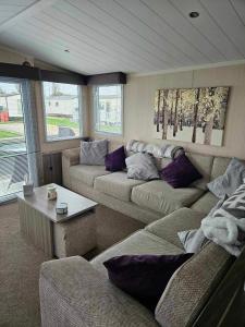 a living room with two couches and a table at Swift Moselle in Lincolnshire