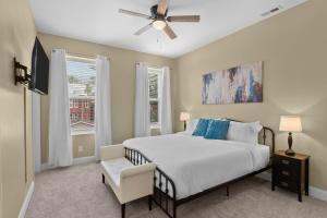 a bedroom with a bed and a ceiling fan at Chic 4-Bed Home near Attractions - JZ Vacation Rentals in Soulard