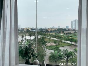 a room with a window with a view of a park at Green Line Long Bien - Serviced Apartment - Ngoc Thuy - Hanoi in Hanoi
