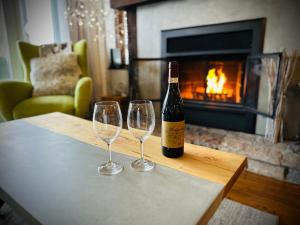 a bottle of wine and two wine glasses on a table at L'Algonquin by Tremblant Vacations in Mont-Tremblant