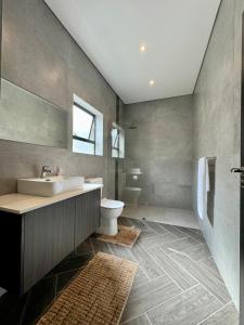 a bathroom with a sink and a toilet at Phoenix Home in Cape Town