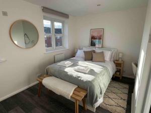 a bedroom with a large bed with a mirror at Entire cosy home in Liverpool Marina in Liverpool