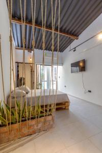 a room with a bed suspended from a ceiling at Apartamento rústico industrial , enfrente de hotel prado in Barranquilla