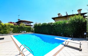 a swimming pool in the backyard of a house at Villa Platani con piscina-BGL in Manerba del Garda