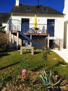 een huis met een terras met een gele surfplank bij Maison rénovée atypique, jardin, terrasse, Odet in Quimper