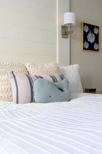 a blue stuffed animal sitting on a white bed at Spectacular Ocean View -Heated Pool and Spa- Seascape in Aptos