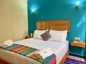 a bedroom with a bed with towels on it at Riad Noor Medina in Fez